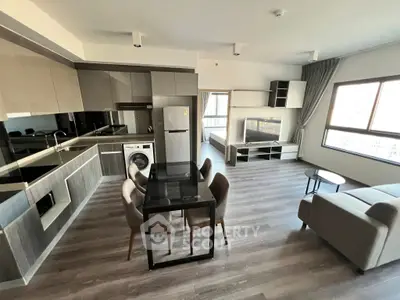 Modern open-plan living room with sleek kitchen and stylish furniture