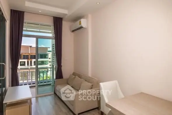 Cozy living room with balcony view in modern apartment