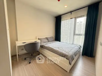 Modern bedroom with city view, featuring a cozy bed and stylish desk, perfect for urban living.