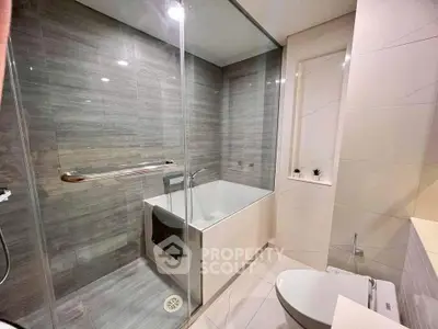 Modern bathroom with sleek design and glass shower enclosure.