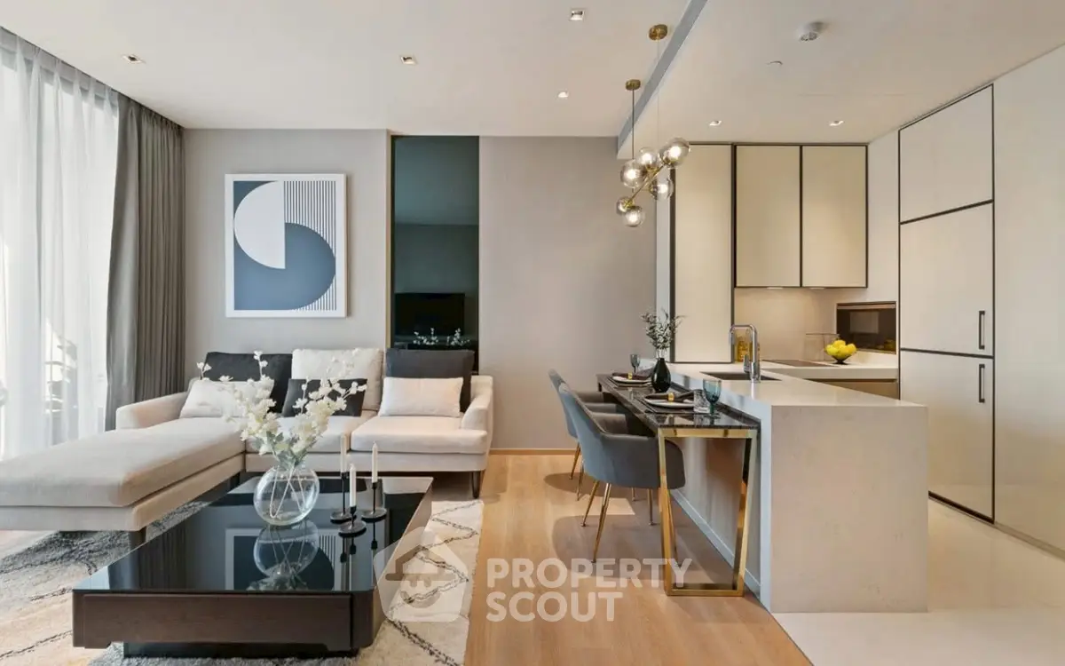 Modern open-plan living room and kitchen with stylish decor and natural light.