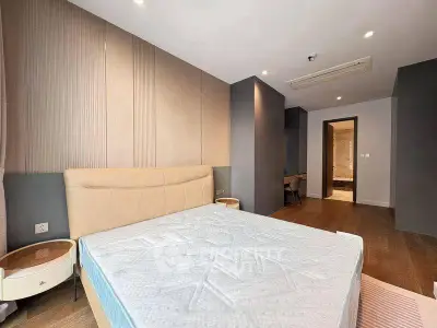 Spacious modern bedroom with stylish decor and ample natural light.