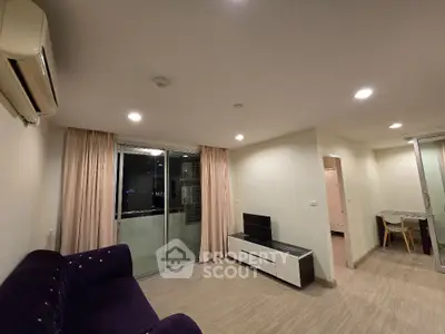 Modern living room with balcony access and sleek furniture