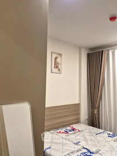 Modern bedroom with stylish decor and cozy ambiance, featuring elegant curtains and contemporary artwork.