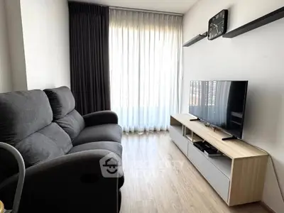 Modern living room with sleek furniture and natural light, perfect for relaxation and entertainment.