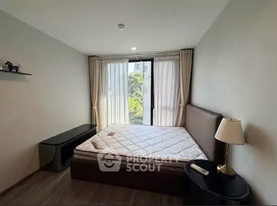 Cozy bedroom with large window and elegant furnishings