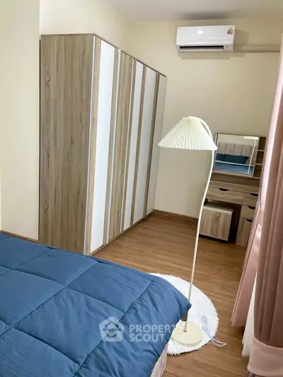 Cozy bedroom with modern wardrobe and elegant floor lamp