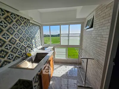 Charming kitchen with scenic view and stylish tile backsplash