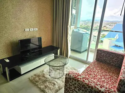 Modern living room with balcony view and stylish furniture in high-rise apartment.