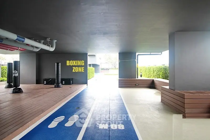 Modern building with outdoor boxing zone and running track, perfect for fitness enthusiasts.
