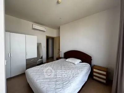 Spacious bedroom with modern furnishings and natural light, perfect for comfort and relaxation.