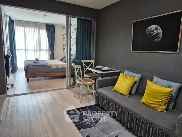 Modern living room with stylish decor and view into cozy bedroom