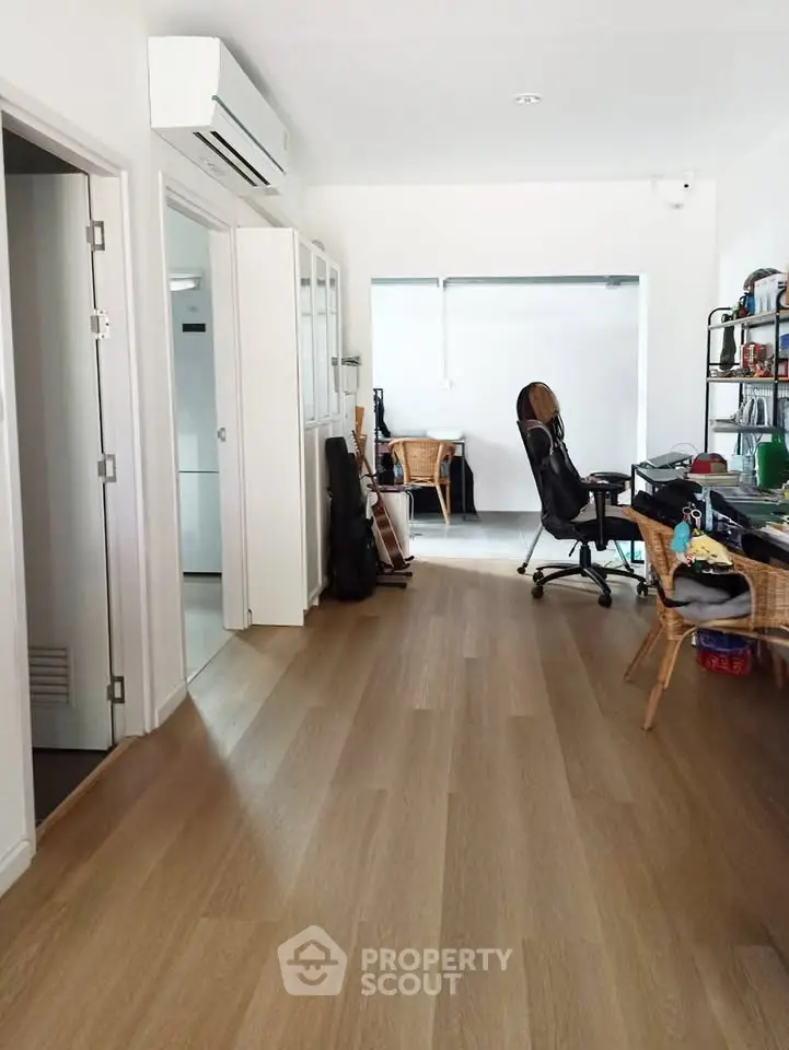 Spacious home office with modern decor and wooden flooring