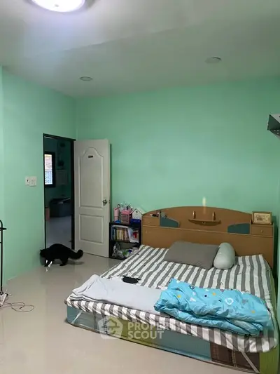 Cozy bedroom with mint green walls and modern furnishings