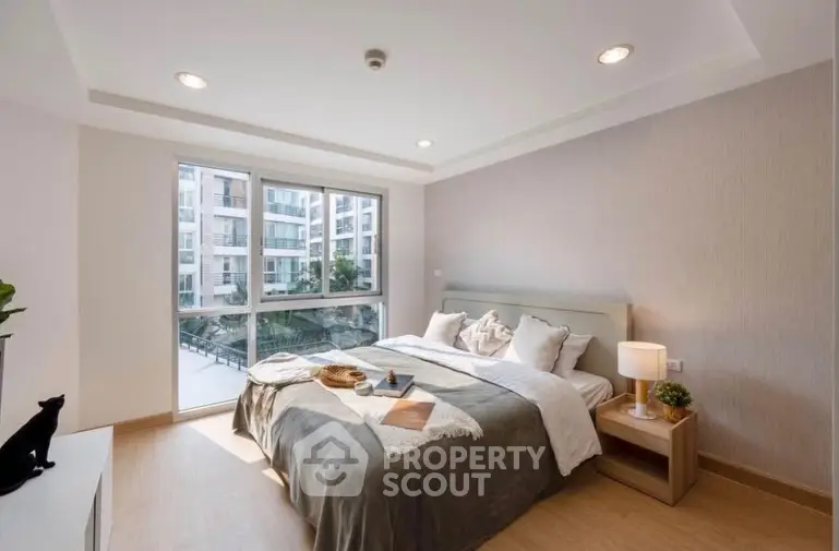 Modern bedroom with large window and stylish decor in urban apartment