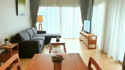 Spacious living room with modern furniture and large windows for natural light.