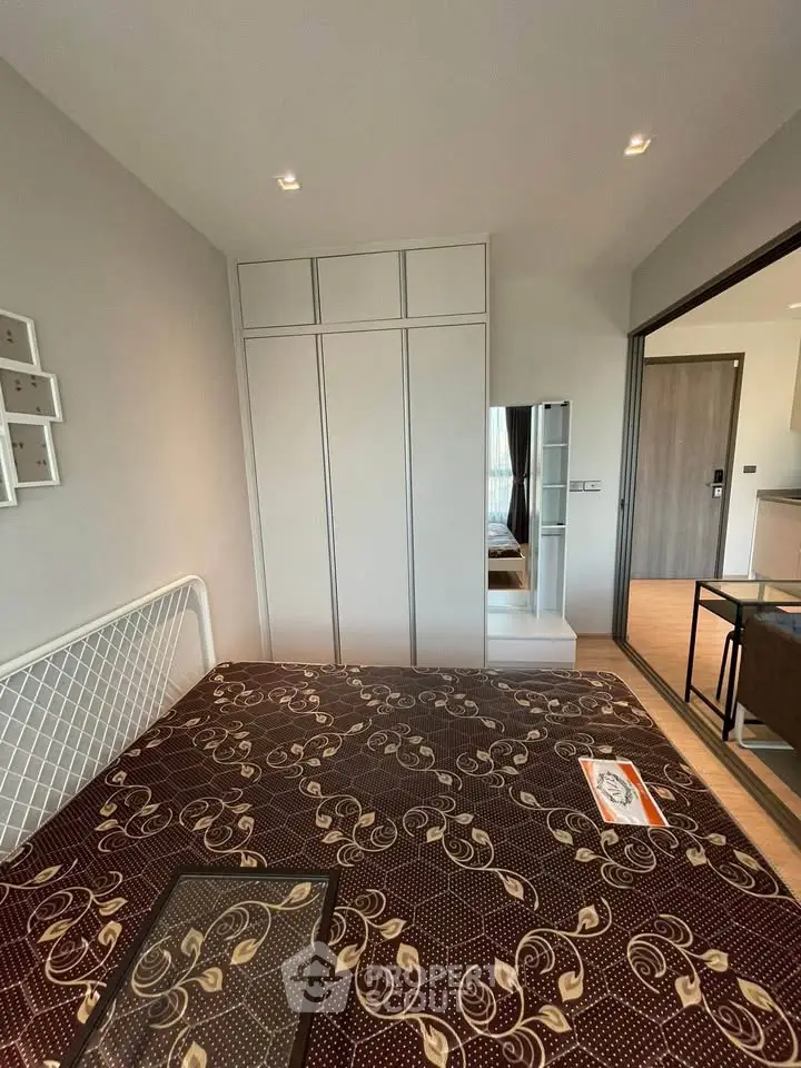 Modern bedroom with stylish decor and ample storage in a contemporary apartment.