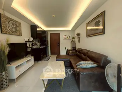 Modern living room with stylish decor, leather sofa, and open kitchen layout in a cozy apartment.