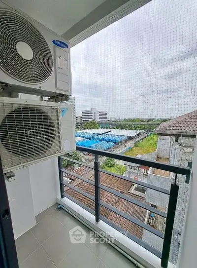 Charming balcony with air conditioning unit and scenic view of urban landscape.