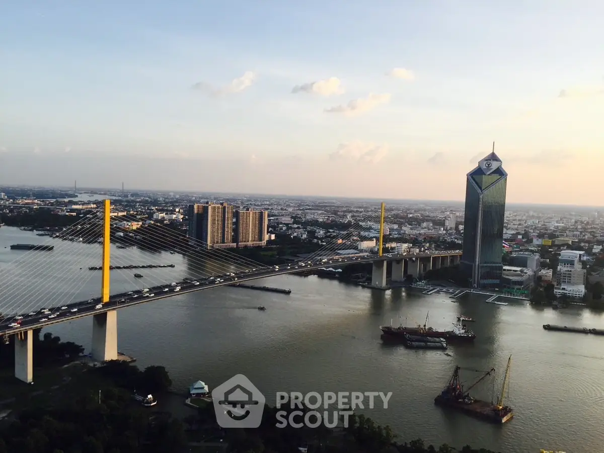 Stunning aerial view of cityscape with iconic bridge and river, perfect for urban living.