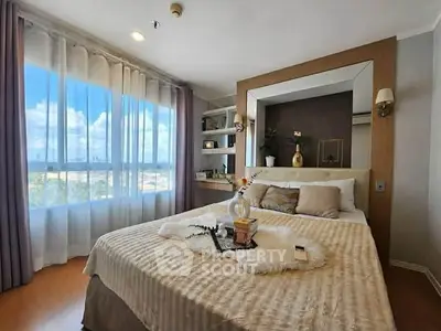Luxurious bedroom with large window and elegant decor, offering a serene and inviting atmosphere.