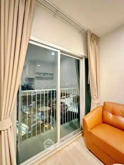 Modern living room with city view from balcony, featuring sleek design and cozy ambiance.