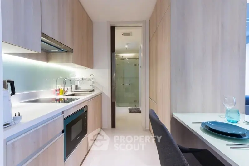 Modern kitchen with sleek cabinetry and integrated appliances in a stylish apartment.