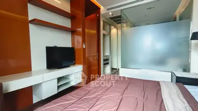 Modern bedroom with sleek wooden shelves and frosted glass partition
