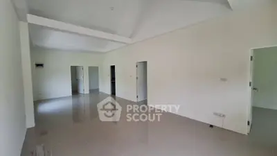 Spacious unfurnished room with tiled flooring and multiple doorways