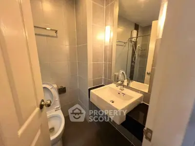 Modern bathroom with sleek fixtures and tiled walls