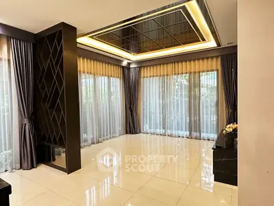 Spacious modern living room with elegant ceiling design and large windows for natural light.
