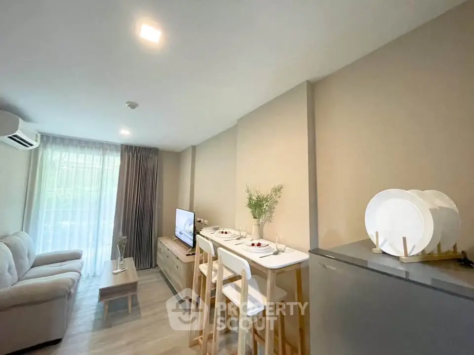 Modern living room with cozy seating and dining area, featuring natural light and stylish decor.