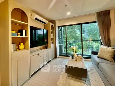 Modern living room with large window and stylish decor overlooking greenery