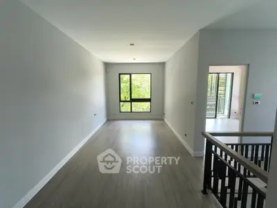 Spacious modern living room with large window and sleek flooring