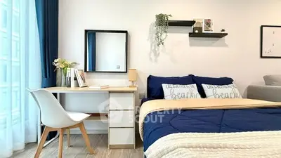 Modern bedroom with stylish decor, cozy bed, and functional workspace near window.