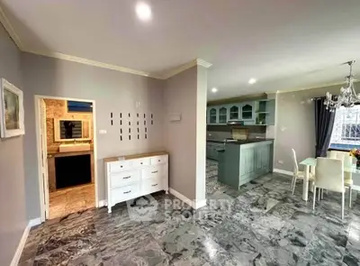 Spacious open-plan kitchen and dining area with elegant marble flooring and modern decor.