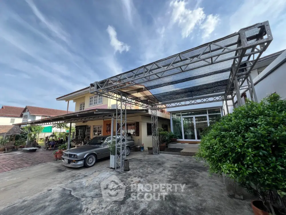 Spacious residential property with carport and lush greenery