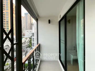 Modern balcony with city view, featuring sleek railing and glass doors, perfect for urban living.