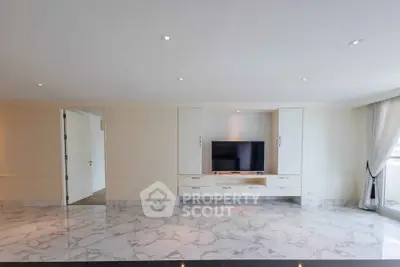 Spacious modern living room with marble flooring and built-in entertainment unit.