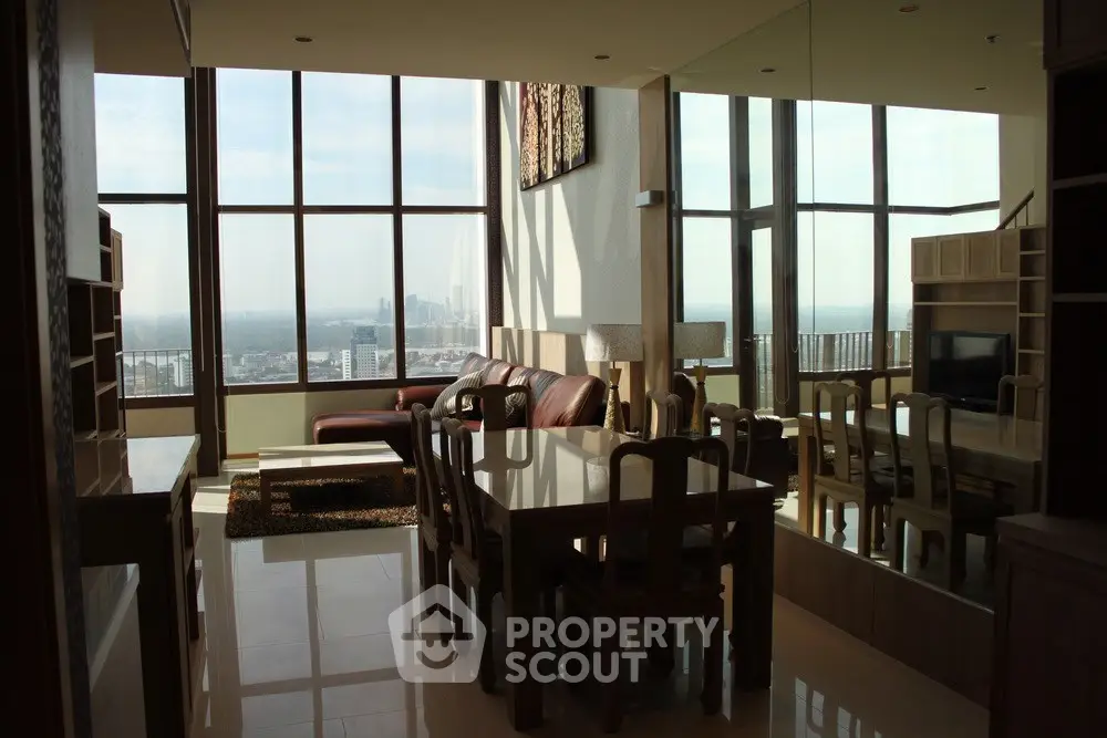 Spacious living room with panoramic city view and elegant dining area