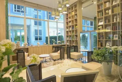 Luxurious modern living room with high ceilings and large windows, featuring elegant decor and ample natural light.