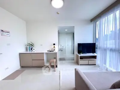 Modern living room with sleek design, large windows, and stylish furniture in a bright apartment.