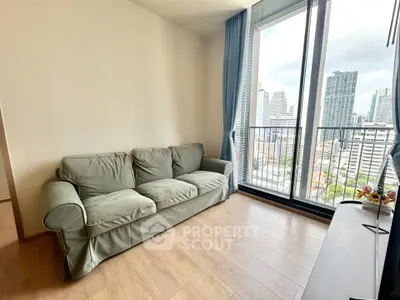 Modern living room with city view and large windows in high-rise apartment