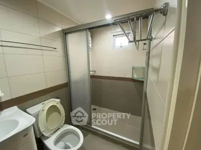 Modern bathroom with sliding glass shower door and compact layout