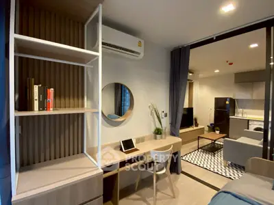 Modern studio apartment with open layout, featuring a cozy living area and stylish kitchen.