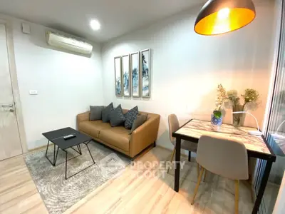 Modern living room with cozy sofa, stylish decor, and dining area in a chic apartment.