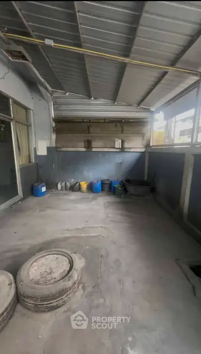 Spacious industrial garage with ample storage and secure metal roofing.