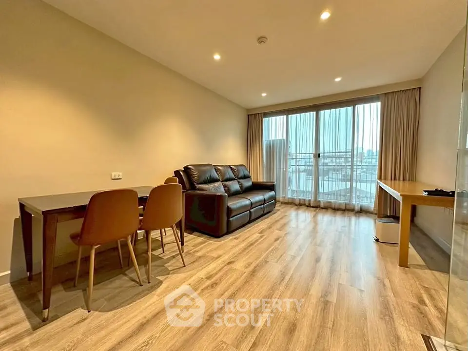 Spacious living room with modern decor and large windows offering natural light.