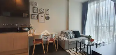 Modern living room with city view, stylish decor, and cozy seating area in a high-rise apartment.