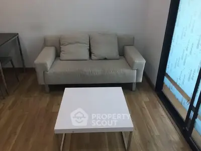 Cozy living room with modern sofa and minimalist coffee table, perfect for relaxation.